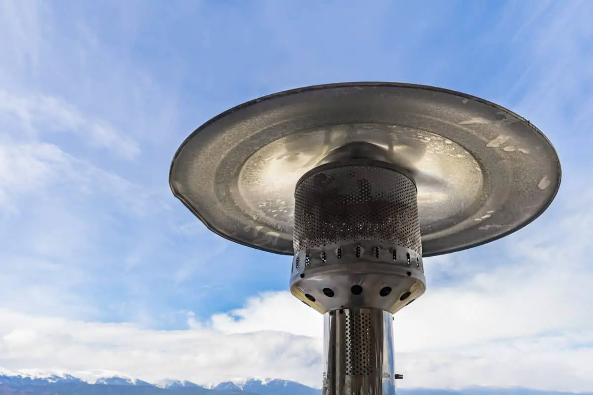 Close up of patio heater with clouds, blue sky and mountains in the background