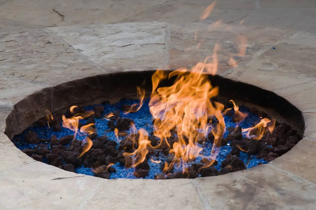 A stone fire pit as an example of the best outdoor gas fire pit on a patio.
