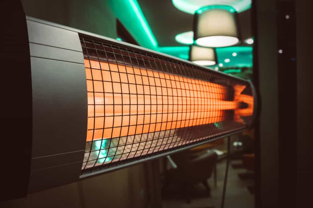 The electric patio heater in the room. heating the apartment in cold weather. Halogen or Infrared heater isolated on a white background.