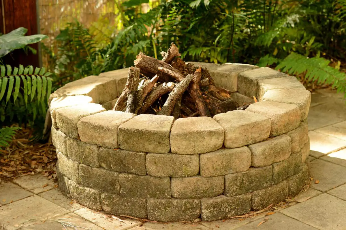 Stone fire pit easily protected with a fire pit cover.