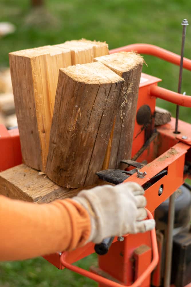 Man using the right size log splitter to cut wood.  