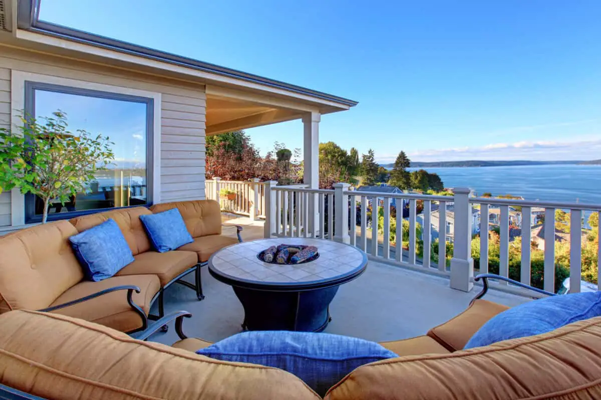 Cozy patio area with comfort settees and fire pit. Deck with Puget Sound view. Tacoma, WA