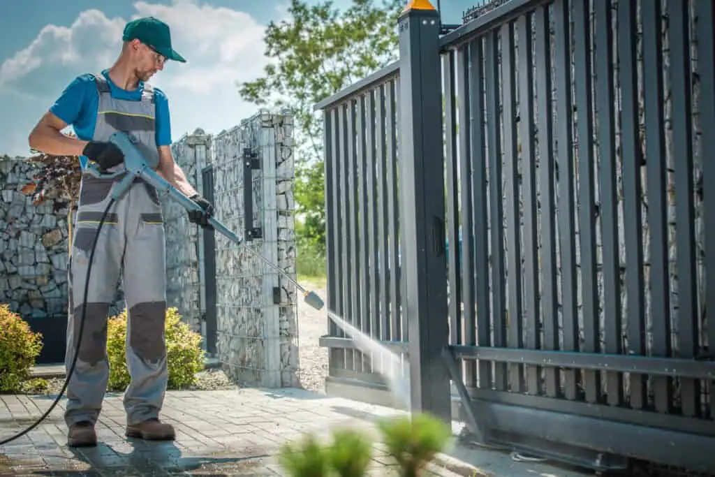 House Driveway and the Gate Pressure Washing by Caucasian Men