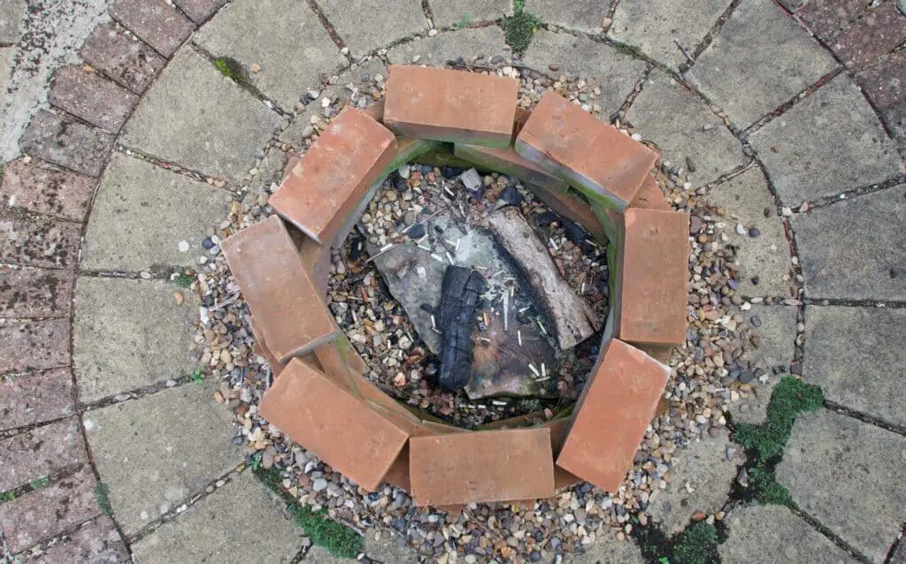 A brick and gravel example of one of many fire pit bases recommended. 