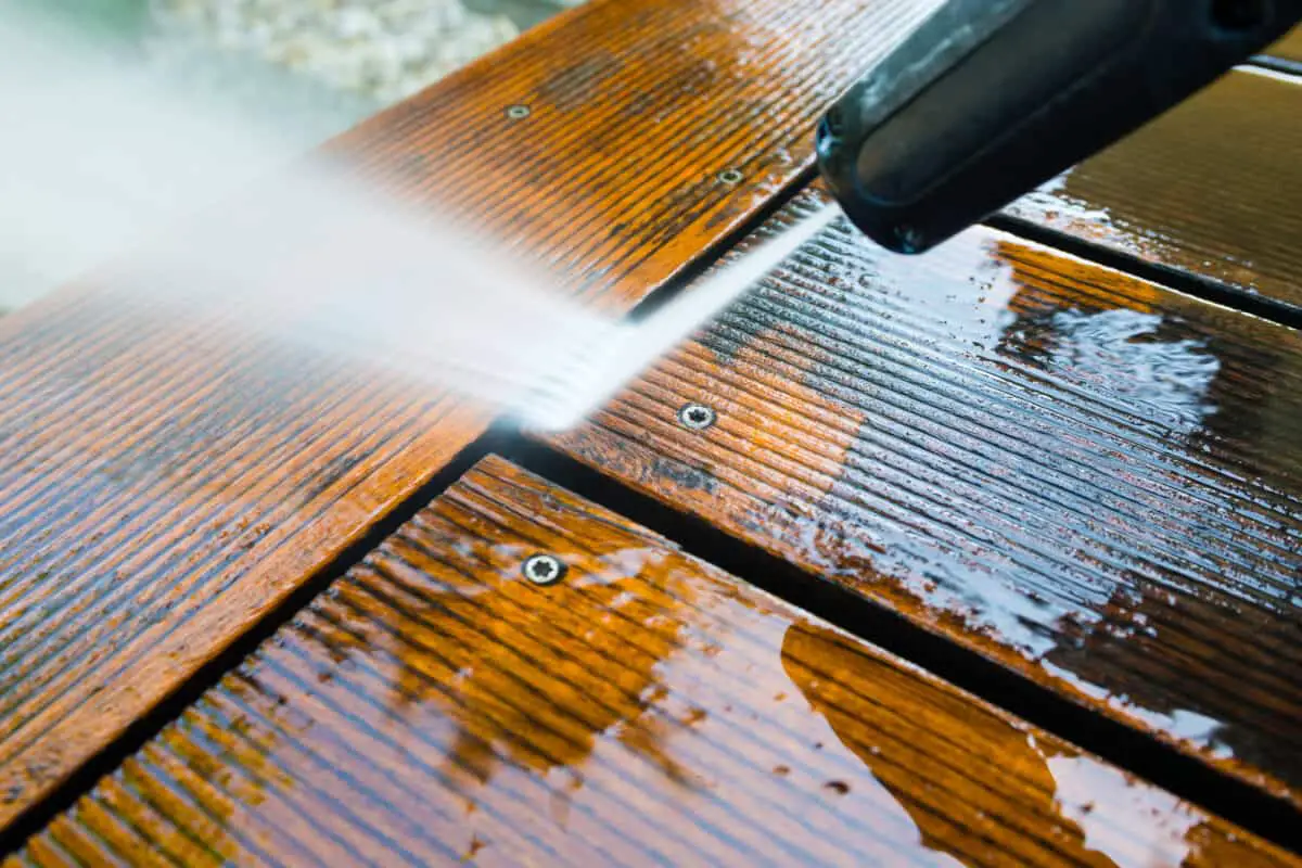 cleaning terrace with a high power washer psi- high water pressure cleaner on wooden terrace surface