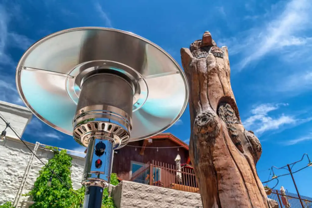 Electric stainless steel metal gas burning outdoor best patio heaters with wheels along with tree trunk on the Route 66.