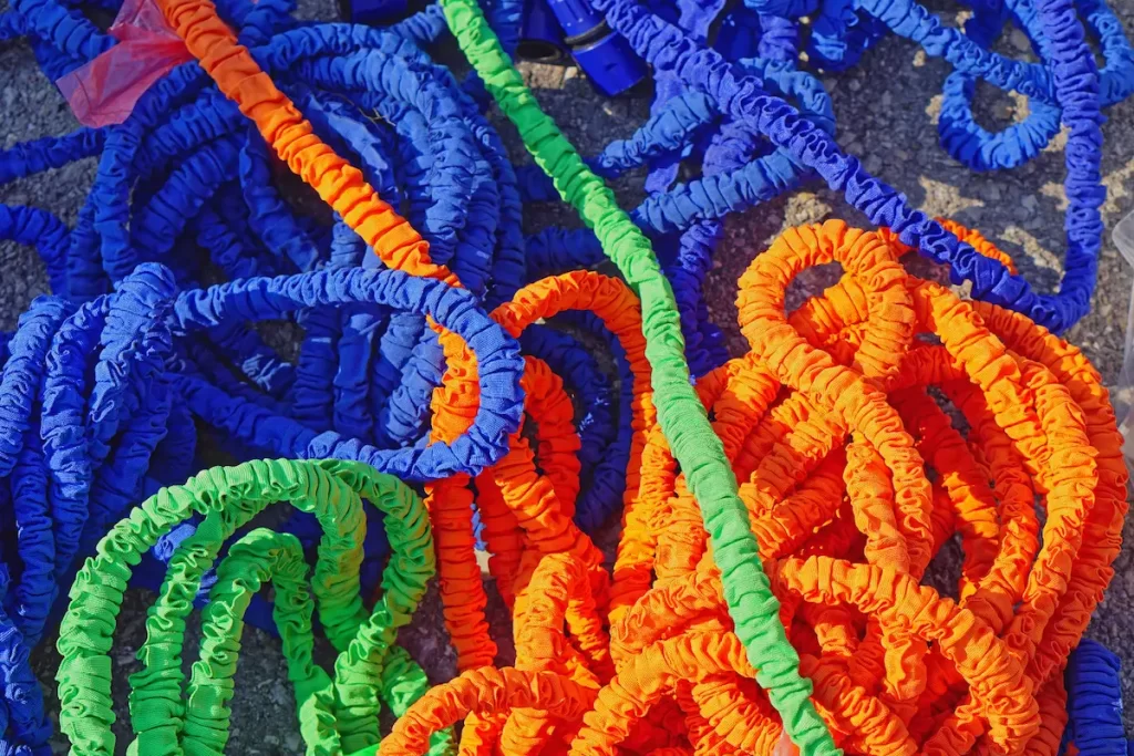 Close up view of varying expandable hoses with a pressure washer.