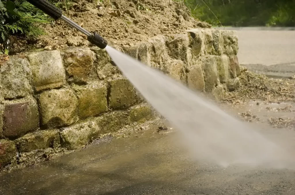 Using pressure washer attempting to remove mulch stains from concrete.