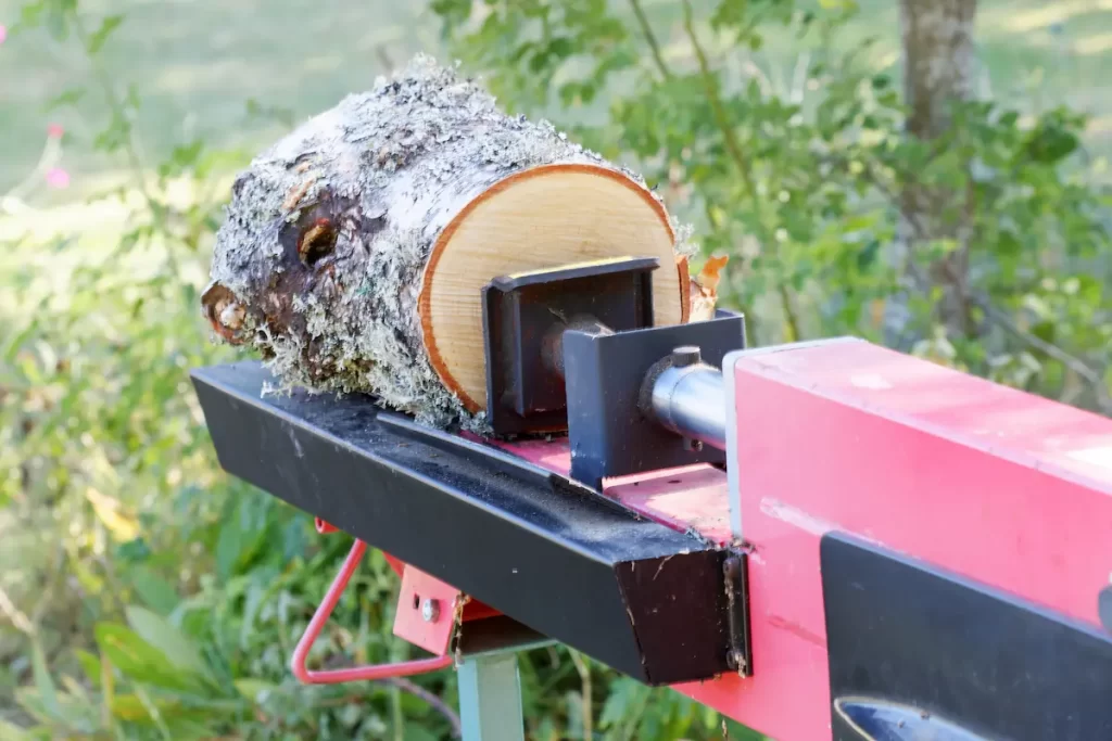 Closeup of kinetic log splitters cutting wood.