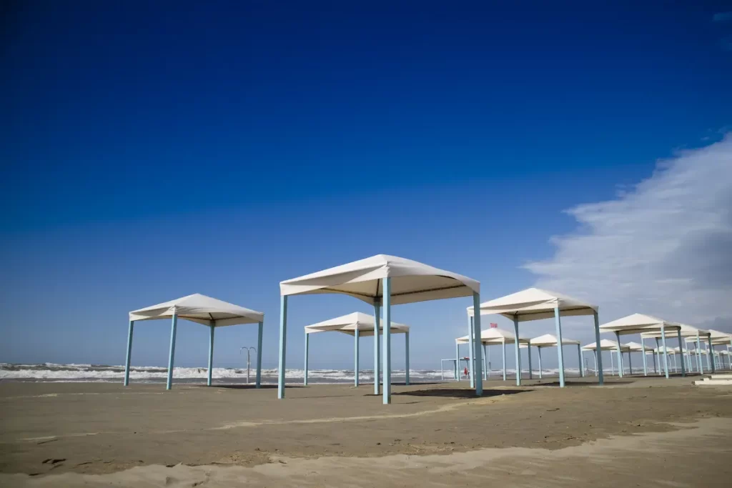 Rows of gazebos on the beach in the winder with blue sky background