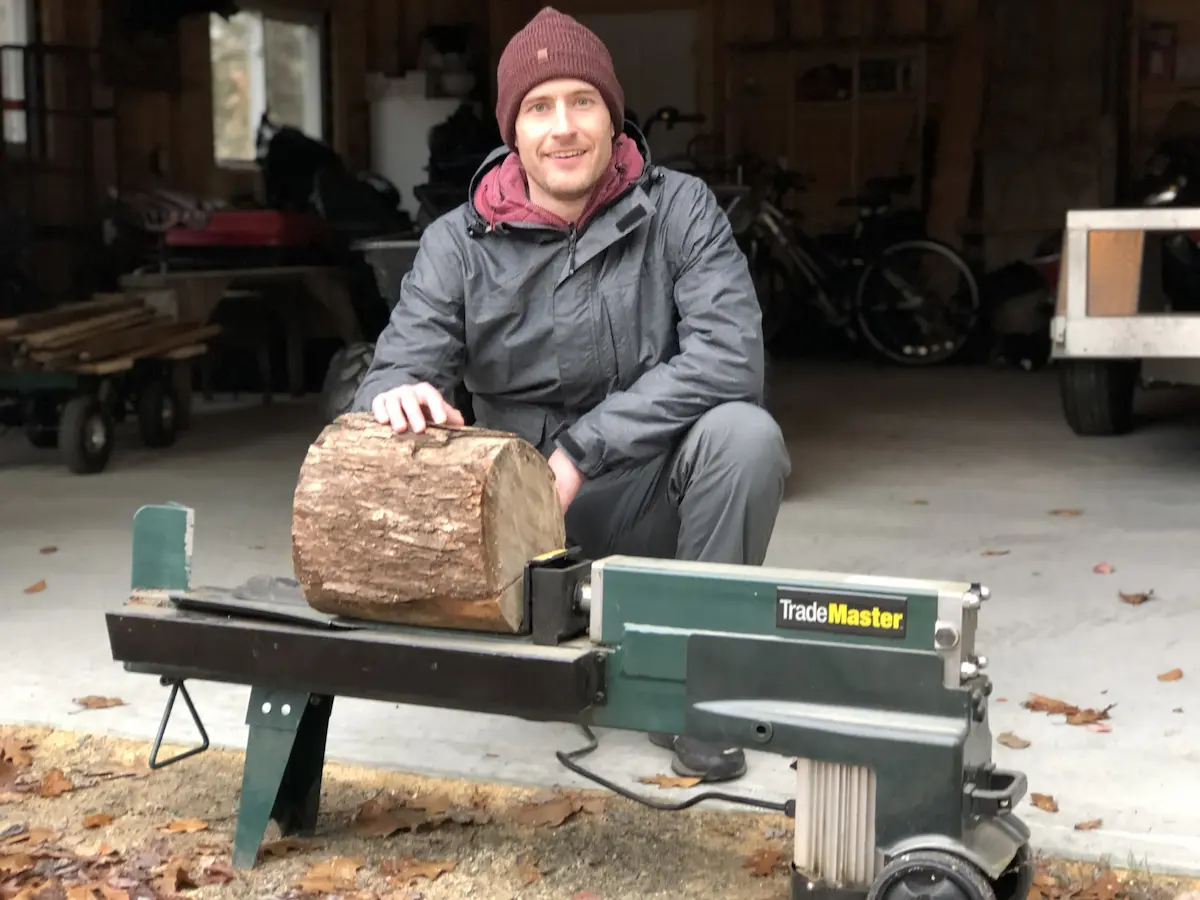 Stuart posing with a log splitter to find out how much it weighs