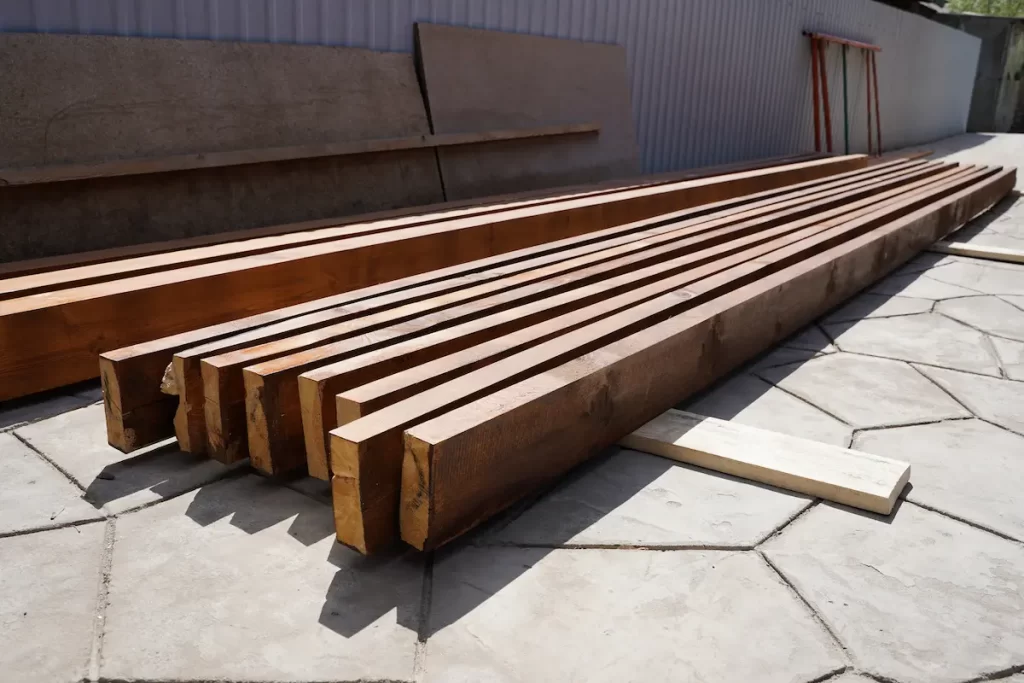 Close up of long beams being used to build pergola showing the best pergola beam size