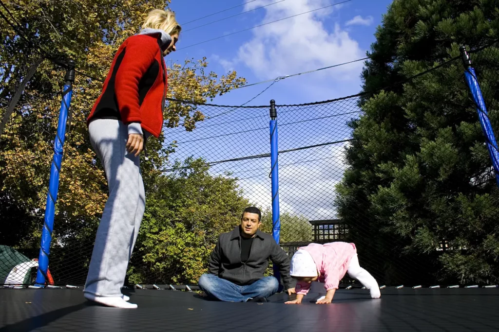 family playing on trampoline