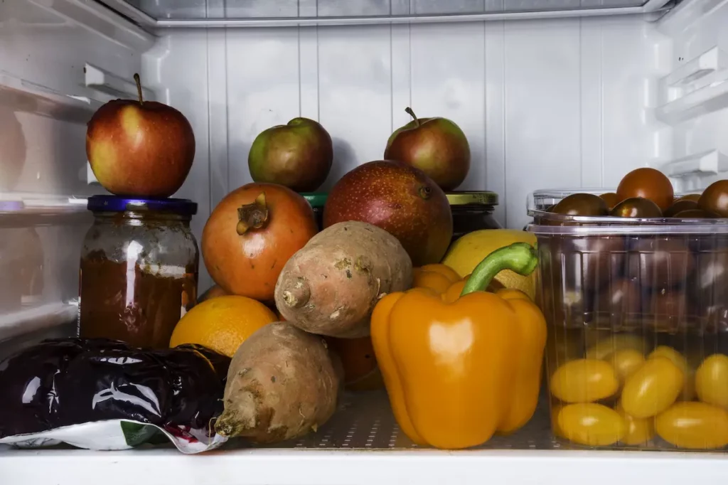 An outdoor fridge with vegetables in it showing the need for an outdoor refrigerator.