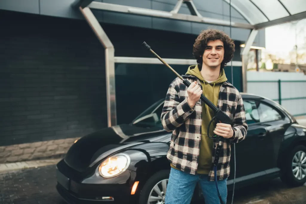 young man about to have fun with pressure washer