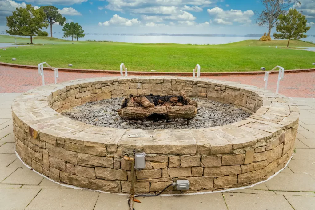 Propane Fire Pit with beautiful lakeview backdrop showing differences between propane fire pits and patio heaters.