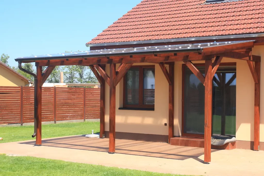 A waterproof pergola roof in the back of a house